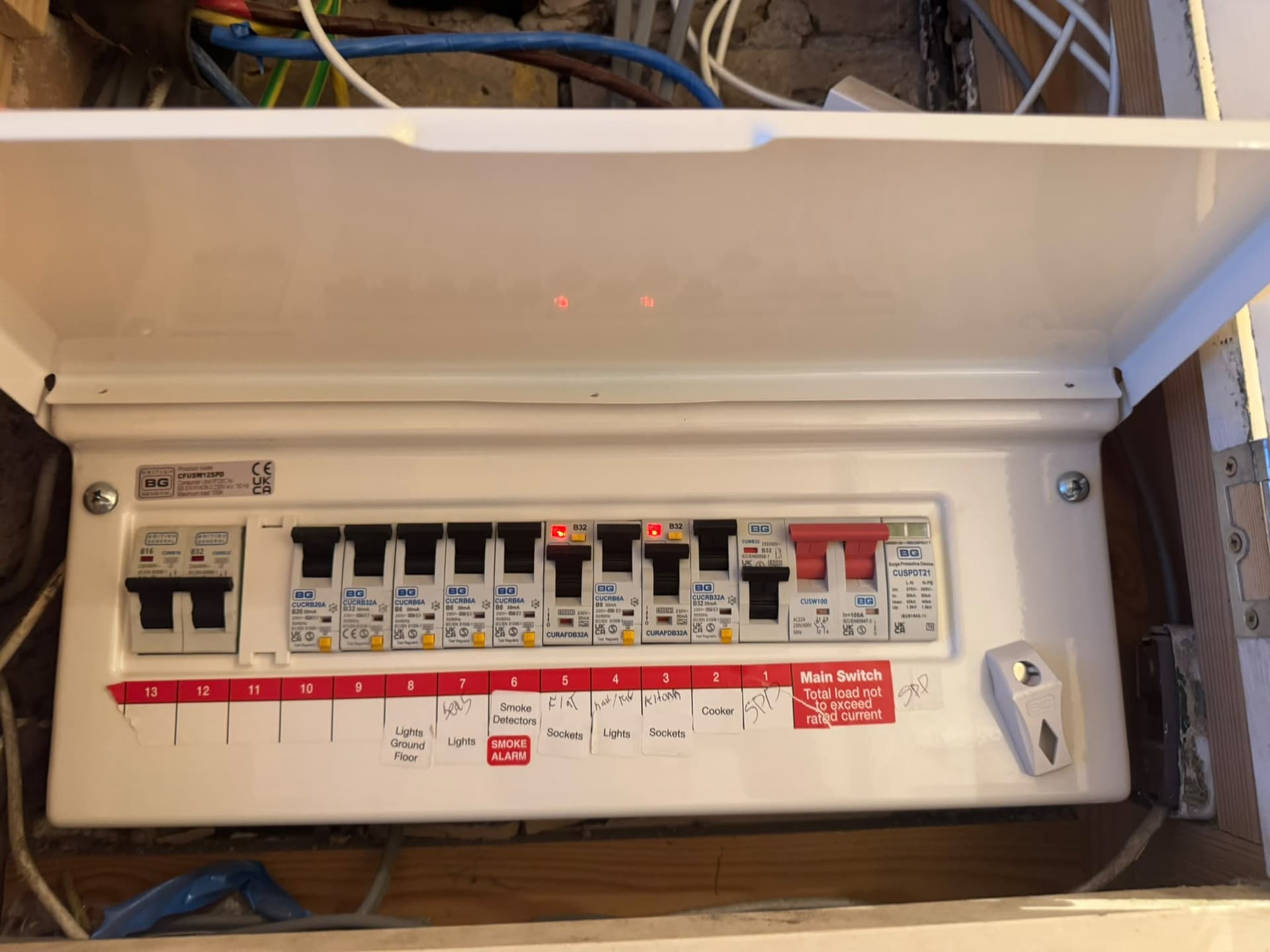 Consumer unit with its cover open, photographed in the original South London inspection record.