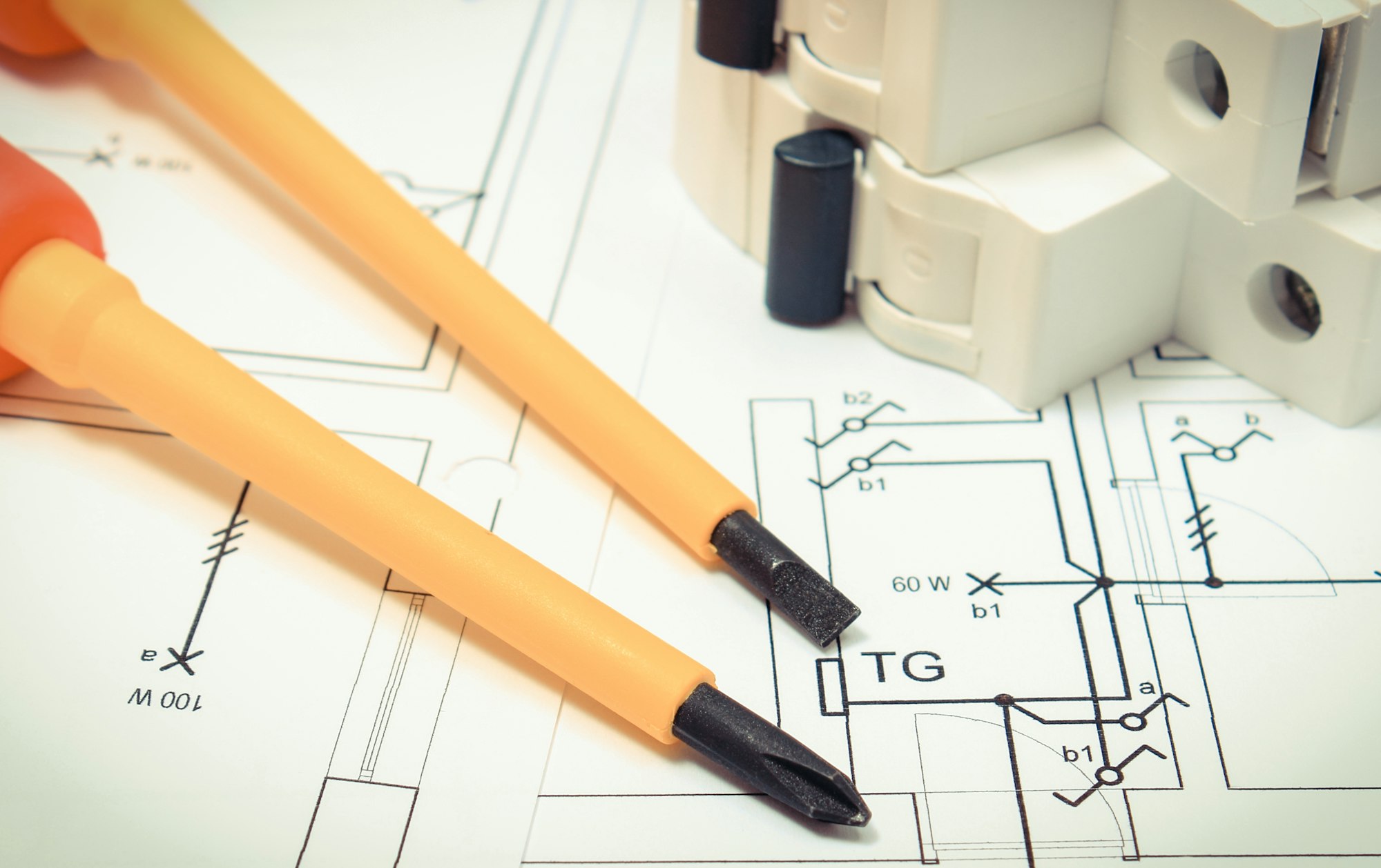 Screwdrivers with electric fuse on construction drawing of house