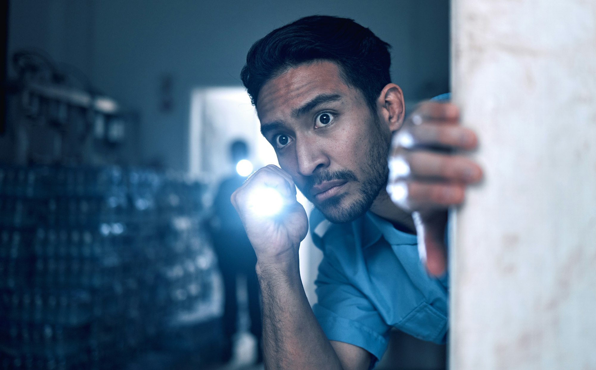 Security, police and man with flashlight for investigation, inspection and property search on night