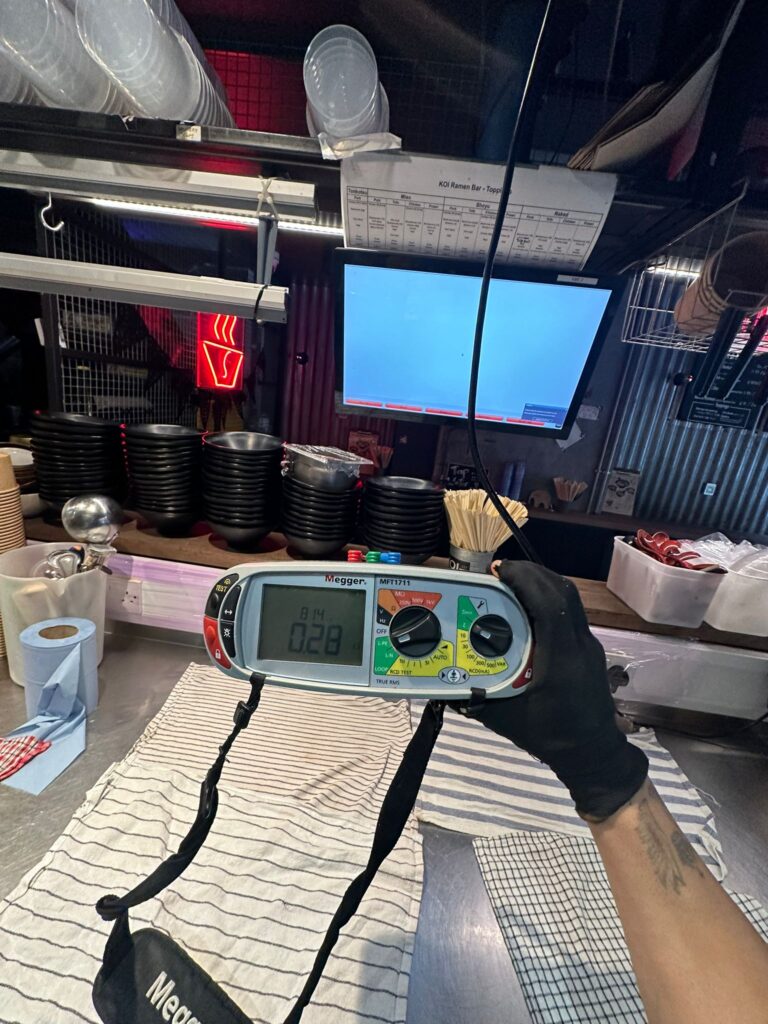 Engineer conducting EICR inspection readings