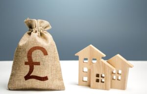 British pound sterling money bag and residential buildings.