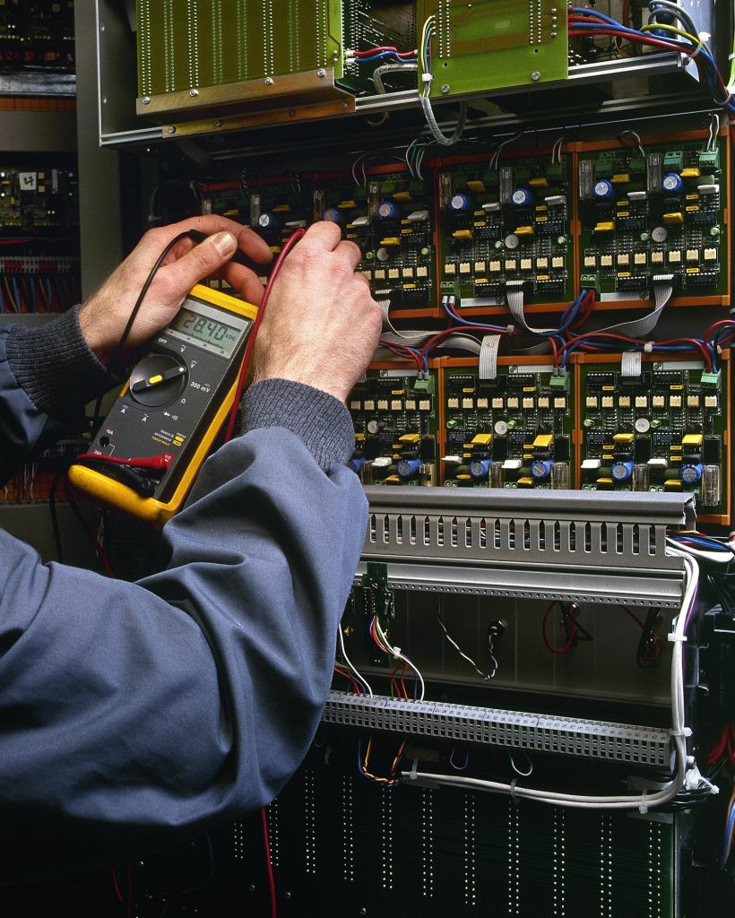 electrician testing industrial machine