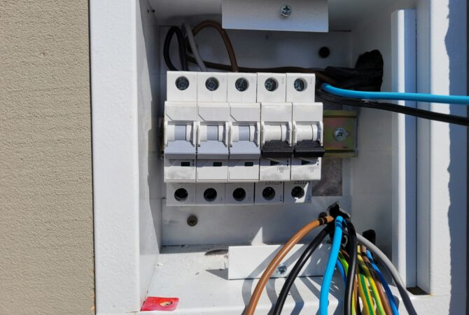 electricity distribution box with wires and circuit breakers